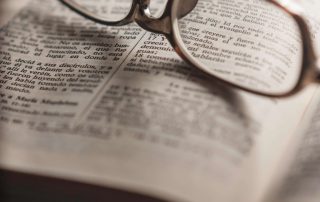 An open Book With Glasses Spanish Classes Houston